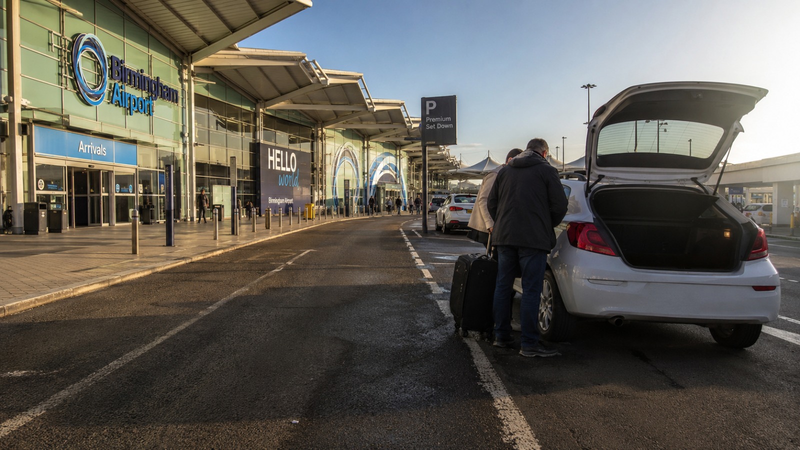  Birmingham Airport Premium Set Down drop-off forecourt with passengers unloading luggage outside the terminal