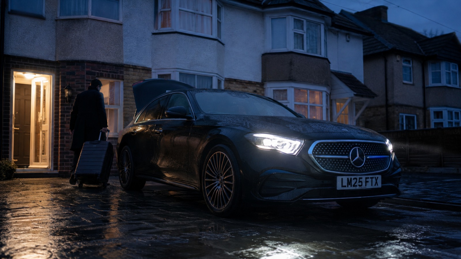 Black Mercedes E-Class saloon on a UK driveway before dawn for an early Manchester Airport transfer