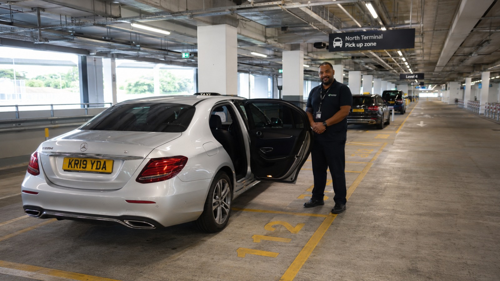 Silver saloon Gatwick airport taxi parked in the North Terminal Express Pick Up zone at Level 4 of Short Stay Car Park 6.