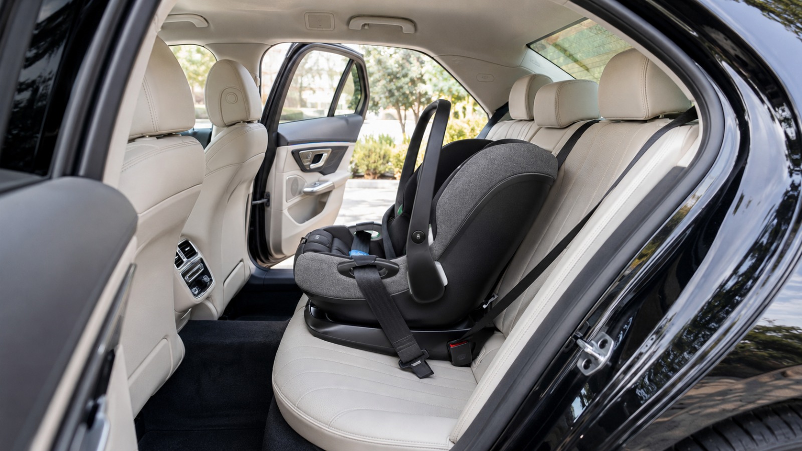 Isofix baby seat installed in the rear of an executive private hire vehicle for a family Luton Airport taxi transfer.