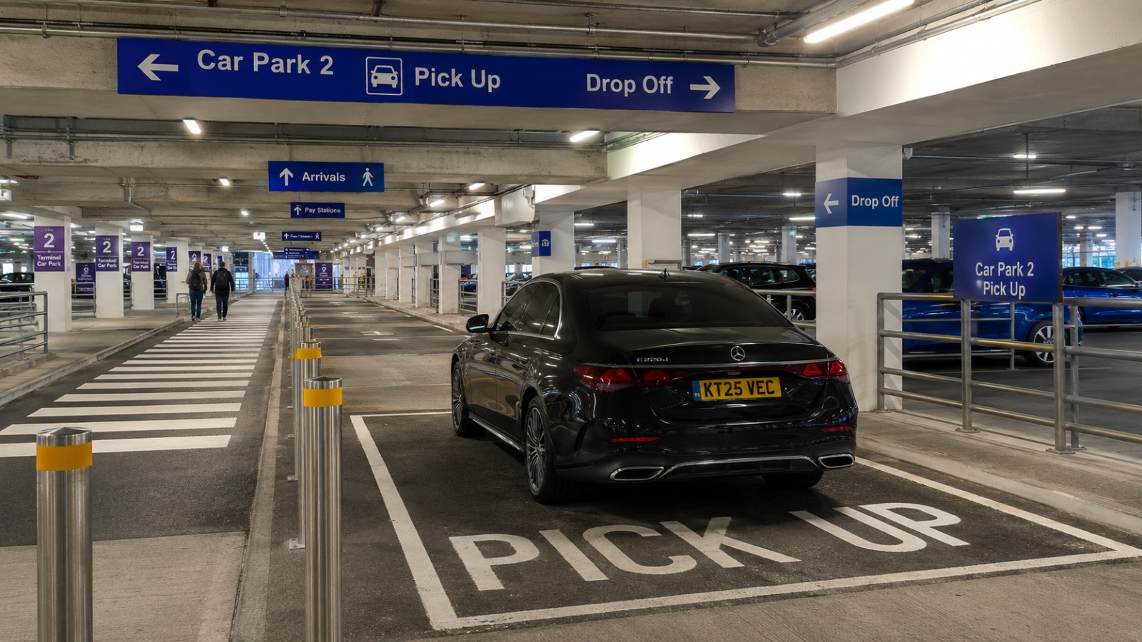 Ground floor pickup and drop off point at London Luton Airport Terminal Car Park 2 with directional signage.