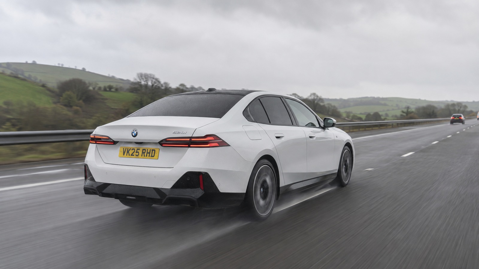 White BMW 5 Series on a UK motorway during a Leeds to Manchester Airport taxi journey